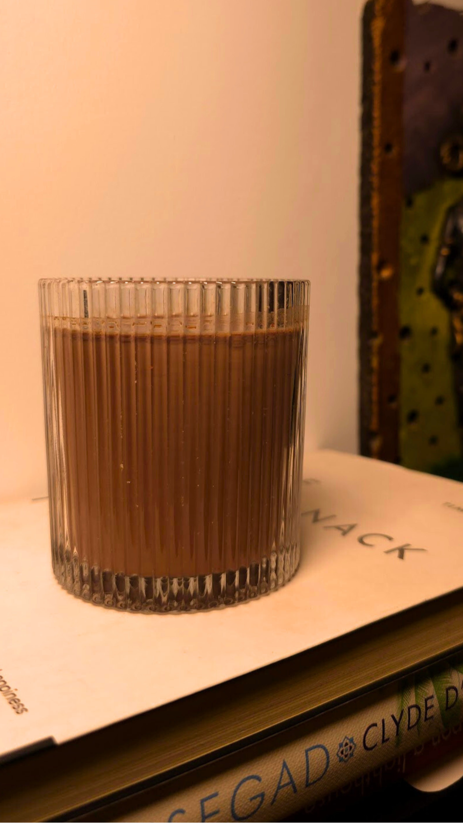 Glass of iced chocolate on a book with a blurred background